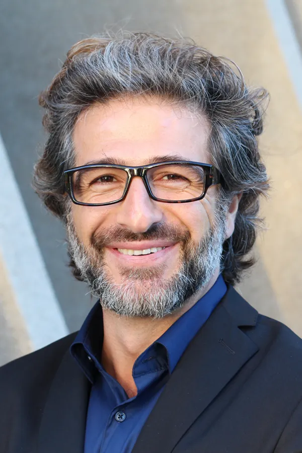 Andropause-and-Low-Testosterone-Treatment A man with glasses, salt and pepper hair and a beard smiling because he received treatment for andropause and low testosterone from Julie Kane, NP of Bird Island Wellness in Calgary.