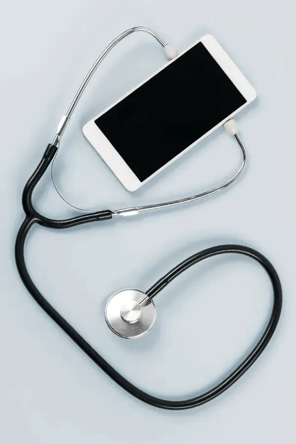 Telemedicine-Treatment A smartphone with a stethoscope attached to it, symbolizing Telemedicine treatment from Julie Kane, NP of Bird Island Wellness in Calgary.